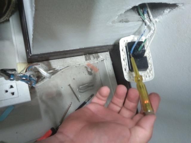 Electrician replacing a wall outlet in a Koh Samui villa home
