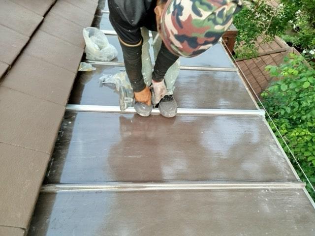 Samui Home Service technician adjusting newly installed awning system with remote control operation