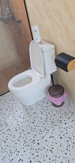 Professional toilet replacement service technician installing modern toilet in Koh Samui bathroom