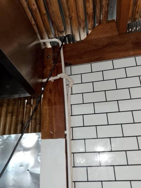 Expert technician installing kitchen exhaust hood in Samui home